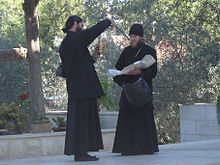 220px-2_priests_checking_merchandise